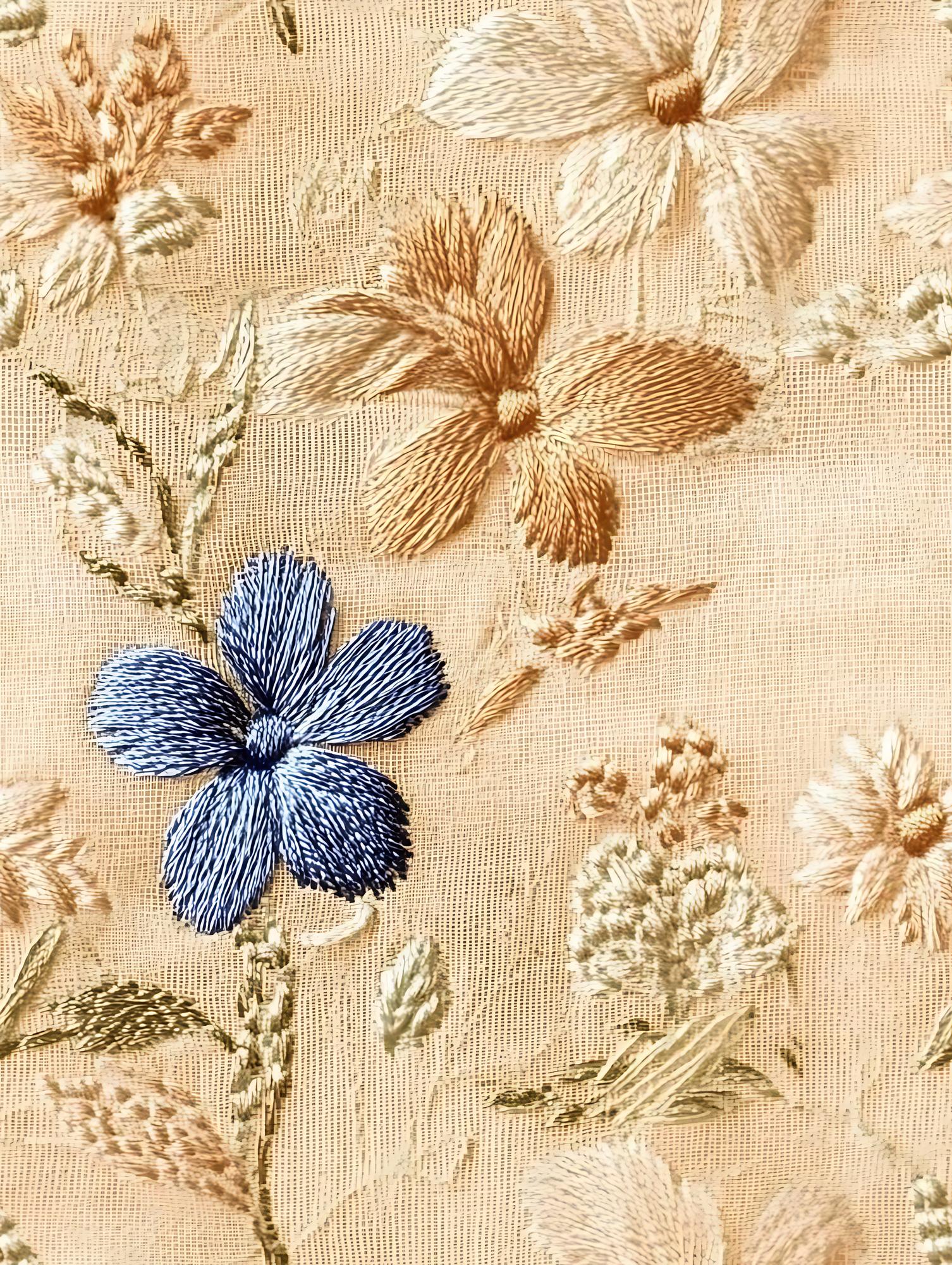 Close-up of embroidered floral motif on linen